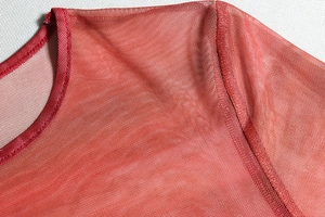 Detail of crew neck stitching on burgundy sheer mesh long sleeve crop top