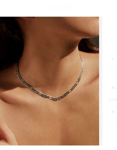 Close-up of S925 sterling silver Figaro chain necklace on female model neck