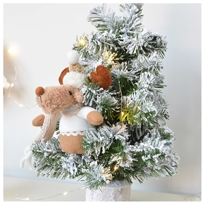 Close-up of reindeer plush ornament with knit scarf on a snowy Christmas tree