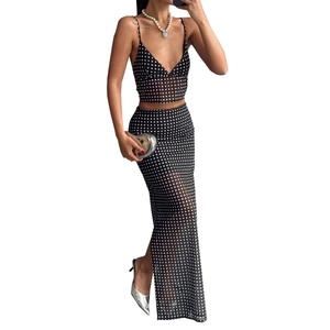 Women's two-piece set featuring black and white polka dot crop top and maxi skirt