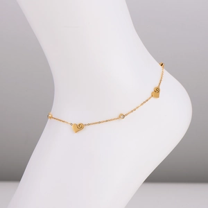 Golden heart and diamond charm anklet in 304 stainless steel worn by a model