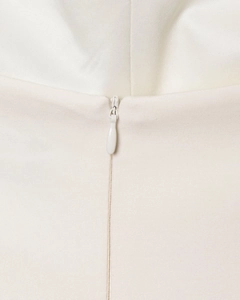Close-up of a high-quality zipper detail on a white sleeveless slim-fit mini dress