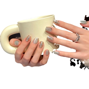 Green Buccellati style press-on nails with luxury cat eye and silver glitter finish