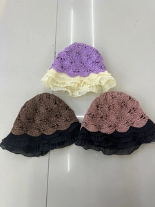 Detail of crochet straw hat showing tiered mesh ruffles and hollow woven texture