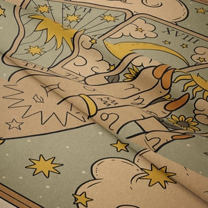 Close-up of vintage tarot tapestry fabric showing sun, moon, and stars texture