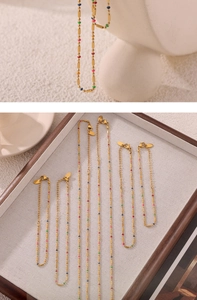Detailed macro view of gold-plated titanium steel chain with colorful enamel beads