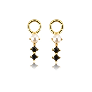 Detail of golden earring featuring a white pearl and two black gemstones with reflections