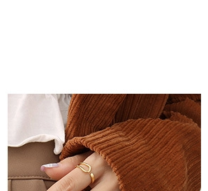 Detailed view of an adjustable minimalist 18K gold plated chain ring worn on finger