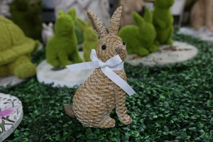 Detailed view of resin Easter bunny statue with realistic woven texture and white ribbon bow