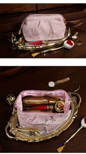 Detail of pink velvet makeup bag with gold star pattern shown open and closed