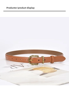 Close-up of caramel brown leather belt with vintage floral engraved gold buckle