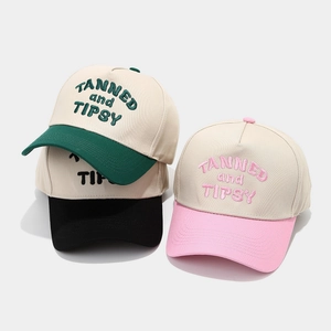 Two-tone cotton baseball caps with TANNED and TIPSY embroidery in various colors