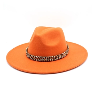 Close-up of bright orange wide brim wool fedora with geometric ethnic woven band