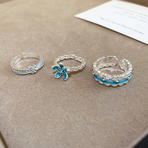 Detailed set of silver open rings with blue flower enamel and zircon accents