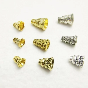 Assorted gold and silver metal bead caps for jewelry making with embossed patterns