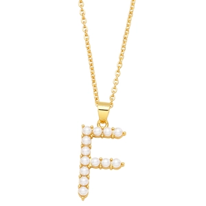 Close-up of golden letter F pendant with small white pearls on a delicate chain