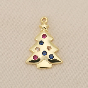 Macro detail of gold Christmas tree pendant with colorful zircon stones and star top