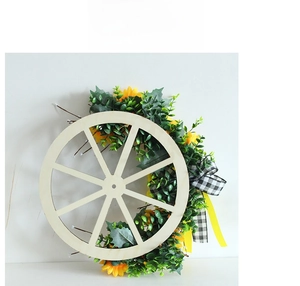 Detail of sunflower wreath wooden wheel decor with black and white gingham ribbon bow