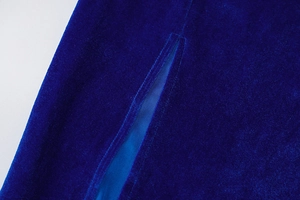 Detail shot of royal blue velvet dress showing side slit and fine fabric texture