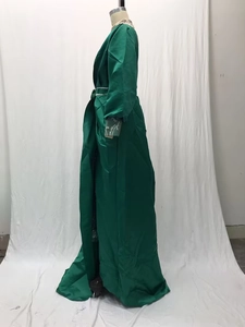 Detail of dark green evening dress featuring silver sequins and rhinestone waist belt
