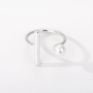 Macro shot of silver adjustable ring featuring a sleek metal bar and a white pearl detail