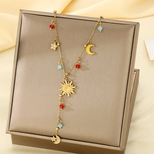 Detailed view of bohemian gold sun, moon, and star pendants on a vintage jewelry display
