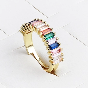 Minimalist golden ring featuring rainbow rectangular zircons in a 45-degree side view