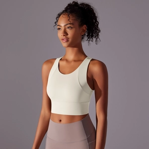 Detail of cream sports bra featuring wide straps and a supportive high-stretch elastic hem