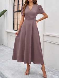 Close-up of elegant mauve V-neck dress featuring textured vertical stripes and pleated waist