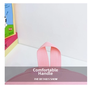 Detail of the pink school bag featuring a comfortable reinforced woven carry handle