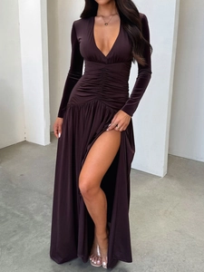 Detail view of deep V-neck and high side slit on elegant burgundy velvet long dress