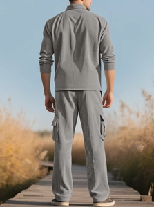 Rear view of men's grey corduroy tracksuit with cargo pants in an outdoor setting