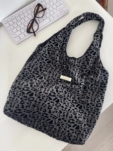 Large gray leopard print tote bag in soft knit fabric shown with a white keyboard