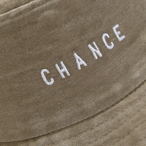 Khaki washed cotton bucket hat with white CHANCE embroidery detail and twill texture