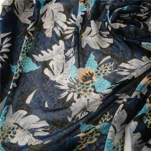 Detail of soft linen-touch navy scarf with tropical leaf prints and leopard accents