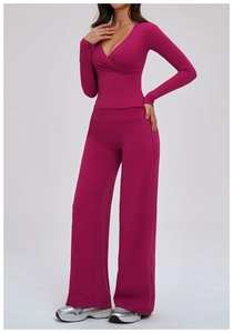 Detail of berry-red yoga set featuring a cross V-neck long sleeve top and wide-leg pants