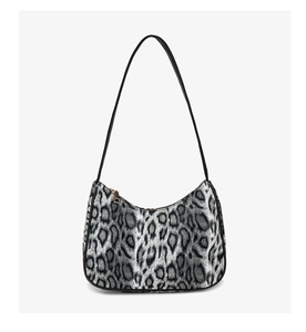 Close-up of leopard print crescent bag featuring soft fabric and gold zipper detail