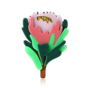 Fashionable acrylic floral brooch with glitter and wood texture on white background