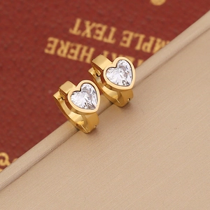 Elegant gold heart huggie earrings with sparkling zircon stones on a red display