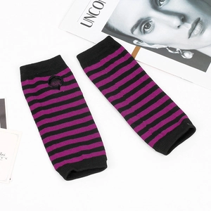 Detailed knit texture of black and purple striped fingerless arm warmers on desk