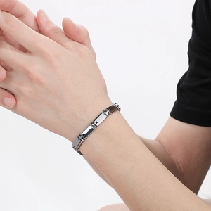 Men's minimalist stainless steel link bracelet in silver and gun-black finish on wrist