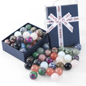 Polished 16mm natural crystal balls set in a blue gift box with decorative ribbon
