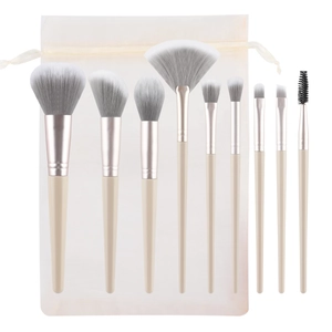 9-piece professional makeup brush set with beige handles and gradient bristles in mesh bag