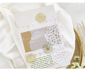 Macro shot of translucent wax seal stickers with butterfly patterns and white lace detail
