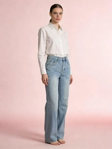 Full body view of a white long-sleeve shirt paired with light blue wide-leg denim jeans