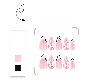 Macro detail of almond press-on nails with pink base, cow print French tips and 3D bows