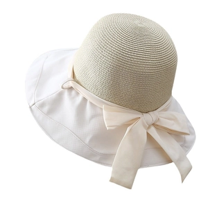 Elegant wide brim straw sun hat with white fabric trim and a large decorative bow tie