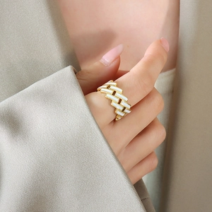 Minimalist gold ring with rectangular white enamel pattern in a geometric chain design