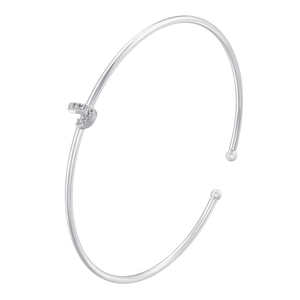 Detail of silver-colored bangle with a sparkling cubic zirconia letter J pendant