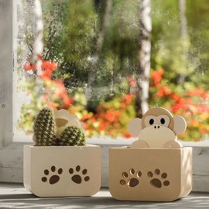 Detail of paw-shaped hollowed patterns on beige animal-themed silicone resin storage pots